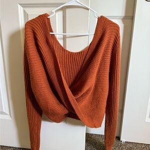 Opened back orange sweater